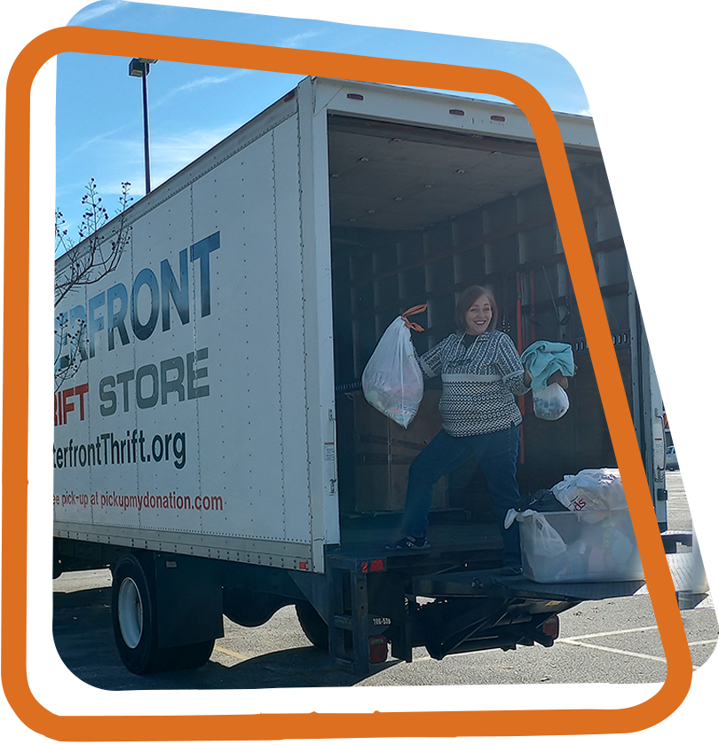 employee collecting a truck full of donations